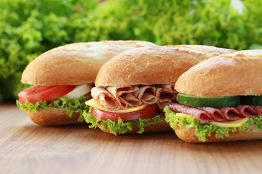 drei frisch belegte Baguettes mit Schinken, Salami und Tomate Mozarella